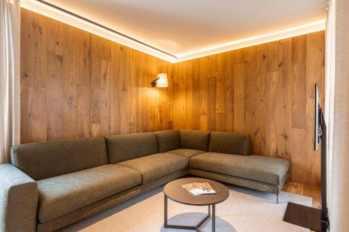 a living room with a couch and a table at Chalet 104 Westendorf by ALPS RESORTS in Westendorf