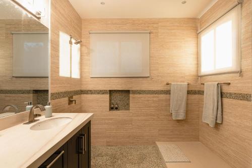 a bathroom with a sink and a mirror at Casa De Los Sueños, Brand New Ocean View Home On 125 Acres! in Brasilito