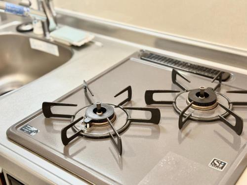 a stove top with two burners on top of it at LANG Hotel GINZA 1K in Tokyo