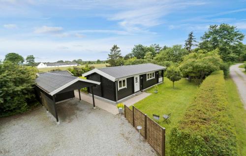 an overhead view of a small black house with a fence at 3 Bedroom Cozy Home In Eskebjerg in Eskebjerg