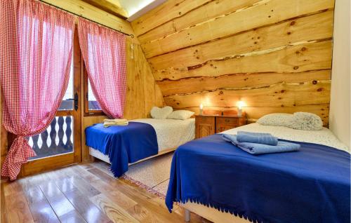 a bedroom with two beds in a log cabin at Beautiful Home In Stubicke Toplice in Stubicke Toplice