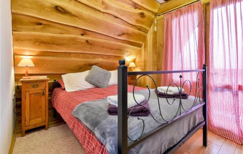 a bedroom with a bed in a log cabin at Beautiful Home In Stubicke Toplice in Stubicke Toplice