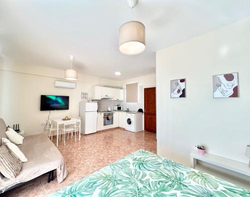 a living room with a bed and a kitchen at SUN JULZ - Eden complex Sea View Studio in Chlorakas