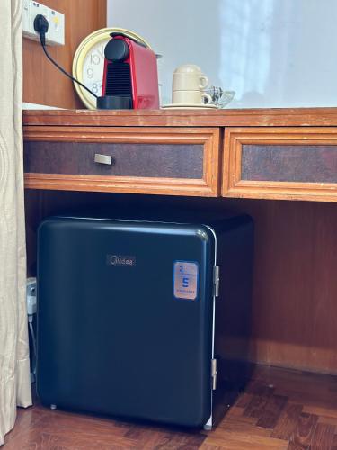 a suitcase sitting under a counter with a table at Luxury Stay with Breakfast & en-suite Bathroom in George Town