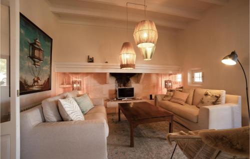 a living room with two couches and a fireplace at Lovely Home In Porto Cristo in Porto Cristo