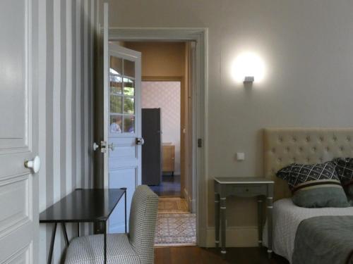 a bedroom with a bed and a table and a chair at villa Aristide Courville in Courville-sur-Eure