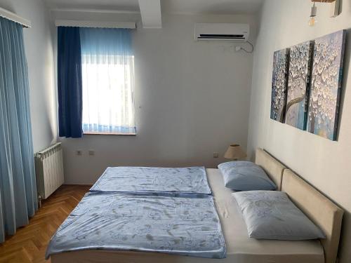 a bedroom with a bed and a window at Guesthouse Vionica in Međugorje