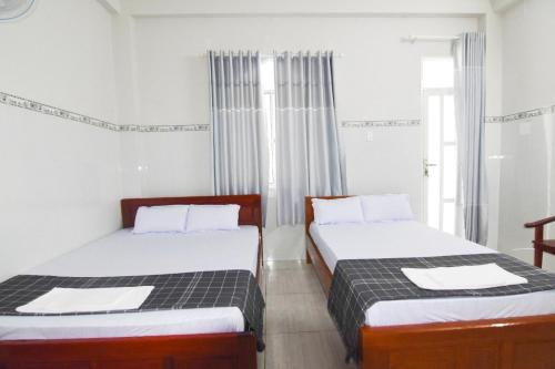 Postel nebo postele na pokoji v ubytování Nhà Nghỉ 80