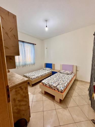 a room with two beds in a room at Vineyard Villa in Himare