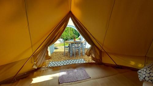 a view from inside a tent with a table at Tente insolite en pleine nature in Tréduder