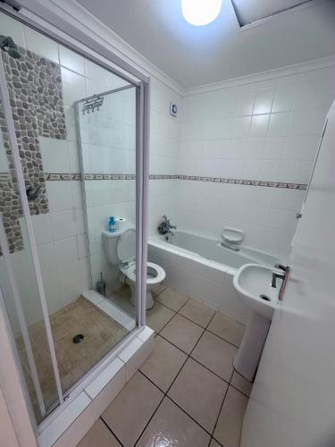 a bathroom with a shower and a toilet and a sink at Luxury 3 Bedroom in Bondi Beach Resort in Shelly Beach