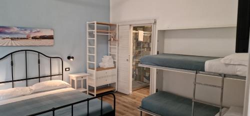 a small room with two bunk beds and a mirror at IL MARINAIO BED&RELAX in Livorno