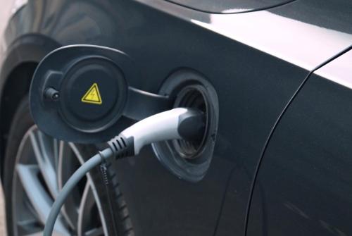 a car with a charging cord plugged into a car at HOTEL DIANA apartments in Prague