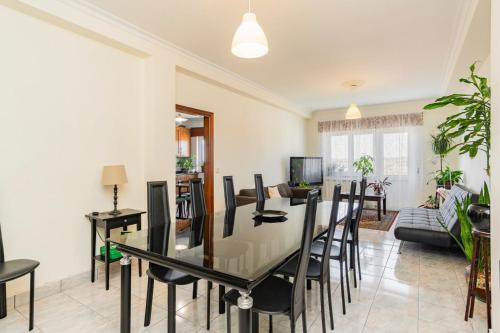 a dining room and living room with a table and chairs at Casa do Olival in Vila Flor
