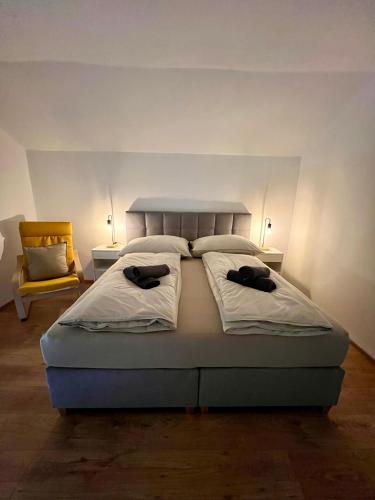 a bedroom with a bed with two hats on it at Dark Sky ONE in Kleinsölk