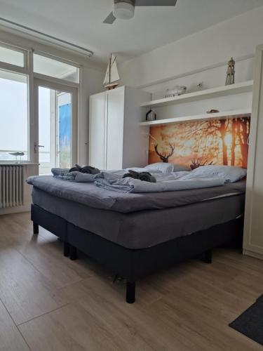 a bedroom with a large bed in a room at Beach & Sea view in Zandvoort