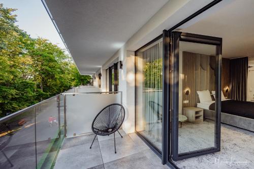 a room with a balcony with a chair at Cristal in Ustka