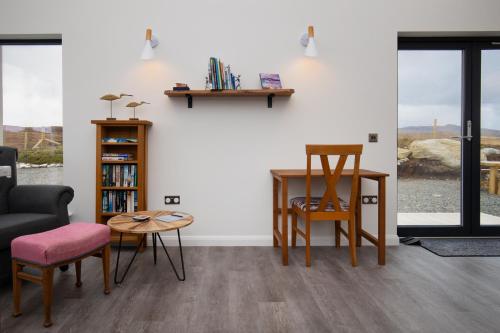a living room with chairs and a table at Modern and Dog Friendly Holiday Home with Sea Loch Views in Breaclete