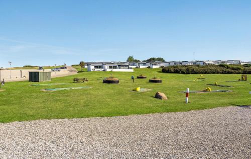 a park with a bunch of playground equipment in the grass at Terrassehus in Fæbæk
