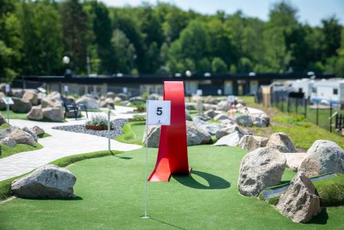 a miniature golf course with rocks and a number sign at Halens Camping och Stugby in Olofström