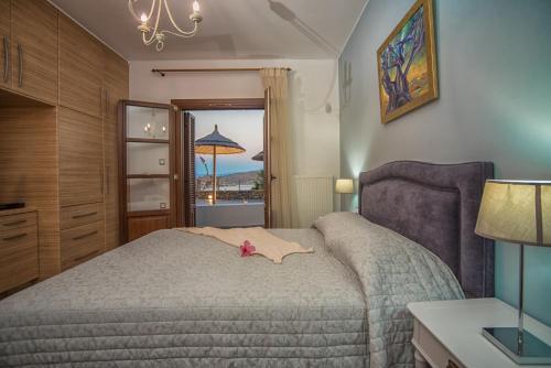 a bedroom with a bed with a pink flower on it at Elounda Maris Villas in Elounda