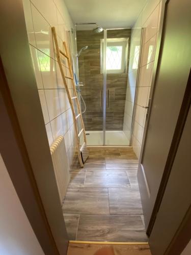 a hallway with a walk in shower and a glass door at Haus Alpentraum in Patergassen