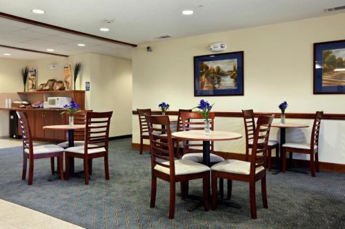 a dining room with tables, chairs, and tables at Rincon Inn and Suites in Rincon