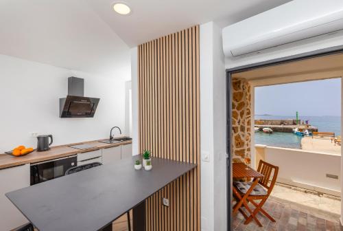 a kitchen with a view of the ocean at SoHo apartment on the waterfront in Mlini