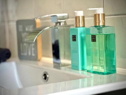 a bathroom sink with two bottles ofodorizers on it at Pures Wohlfühlen mit privater Sauna & Garten in Meschede