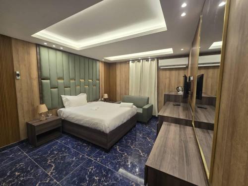 a hotel room with a bed and a television at La Luna in Bangui