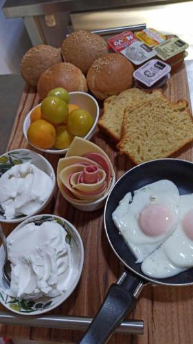 a table with a pan and a bunch of food at Orfeas Studios Molivos in Mithymna