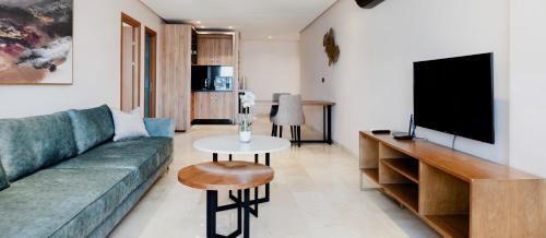 a living room with a green couch and a table at AS Premium By Soho Hotels Maarif in Casablanca