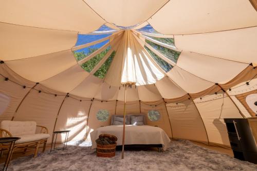 a bedroom inside a tent with a bed in it at Holmegaard vin og glamping in Dannemare