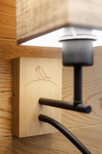a wire plugged into a wooden box with a light at BIO HOTEL & WELLNESS Zlatý Hýľ in Hýľov