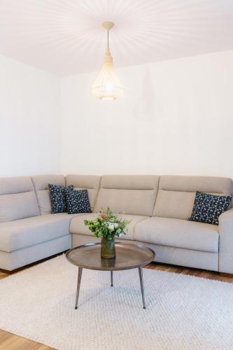 a living room with a couch and a coffee table at BIO HOTEL & WELLNESS Zlatý Hýľ in Hýľov