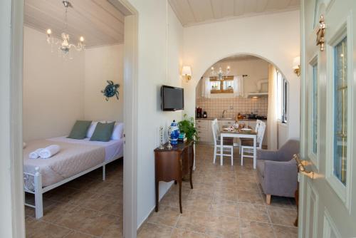 a bedroom with a bed and a table and a kitchen at Casa Gaia in Gaios