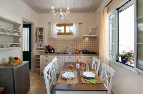 a kitchen with a wooden table and chairs and a dining room at Casa Gaia in Gaios