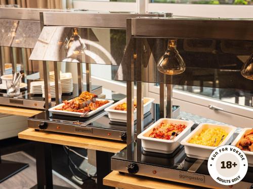 a buffet line with dishes of food on display at Ærø Hotel - Adults only in Marstal