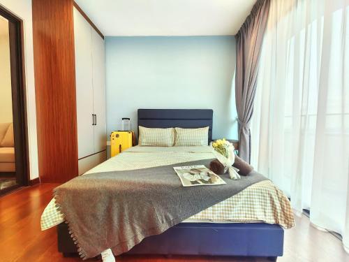 a bedroom with a bed with a book on it at Almas Suites 스타일리시 무지 스튜디오, 스텔라 국제학교까지 도보 2분 STAY in Nusajaya