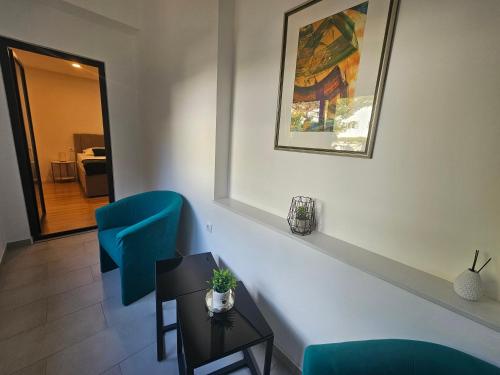 a room with two blue chairs and a table at Laurus Makarska Accommodation in Makarska