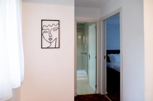een kamer met een foto van een gezicht op de muur bij Lev Or Aparthotel in Boekarest