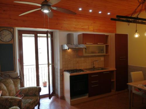 a kitchen with a stove and a ceiling fan at Casa Ruffo in Francavilla di Sicilia