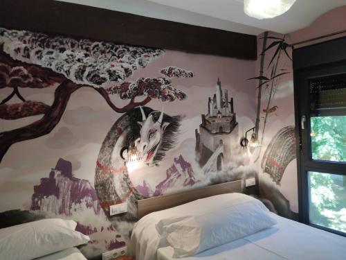 a bedroom with a castle mural on the wall at FamilyHostelPinto in Pinto