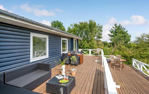 a deck of a house with a blue house at Awesome Home In Kalundborg With Wifi in Kalundborg