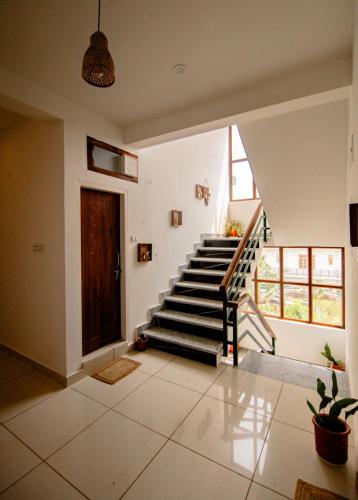 a staircase in a house with a stair case at The Jungalow by AVVAs Stays in Bīr