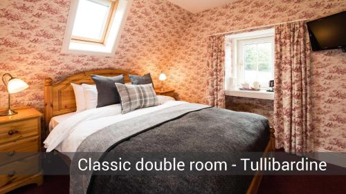 a bedroom with a bed and a window at McKays Hotel in Pitlochry