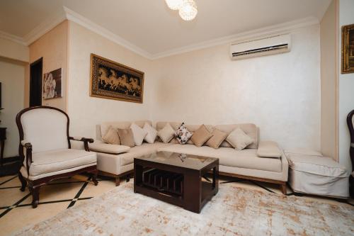 a living room with a couch and a fireplace at Elegant Stay in Mohandessin in Cairo