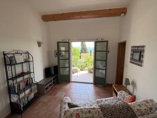 - un salon avec un canapé et une porte ouverte dans l'établissement Gite with Pool, 900 metres walk to Saint Saturnin Les Apt, à Saint-Saturnin-lès-Apt