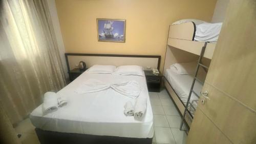 a bedroom with a bed and a bunk bed at Sunrise Hotel Cameria in Durrës