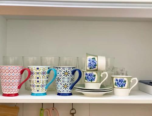 a row of colorful cups sitting on a shelf at Gangnam Station Fun House in Seoul
